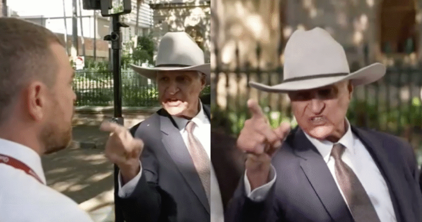Bob Katter speaking at a press conference with an Australian flag